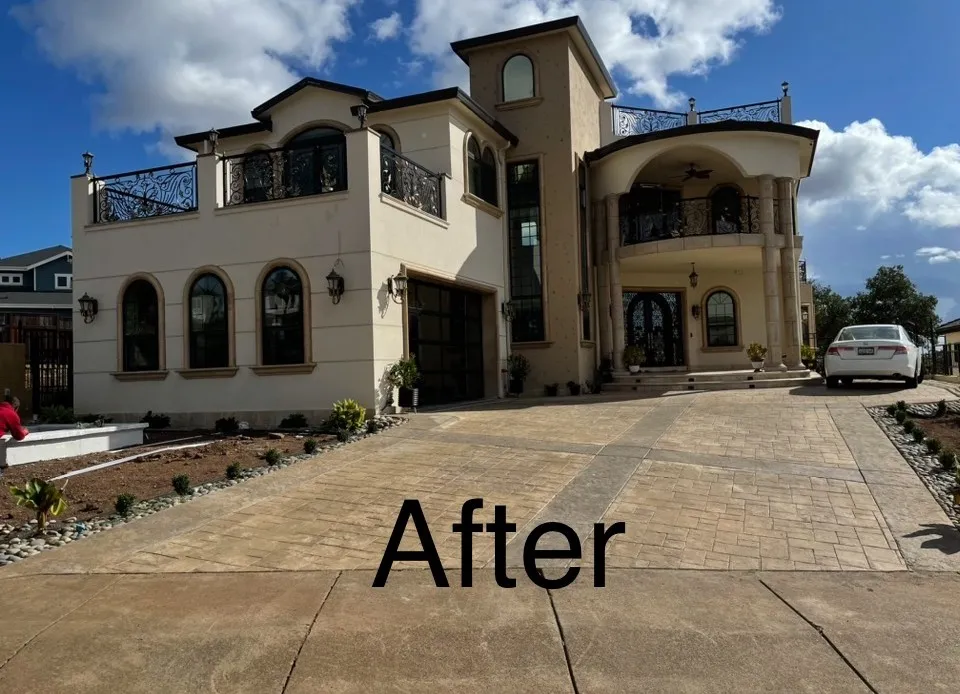 Completed stucco estate with stamped concrete driveway and arched windows (after)