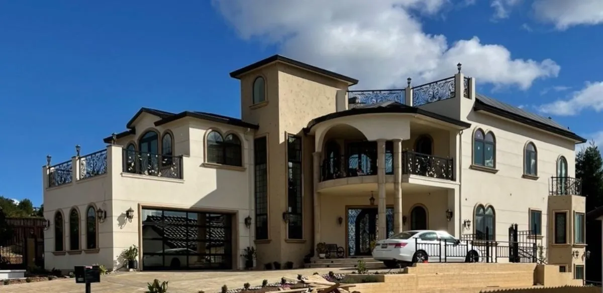 Completed Mediterranean-style estate with custom stucco finish and wrought-iron balconies — new construction stucco in Santa Rosa