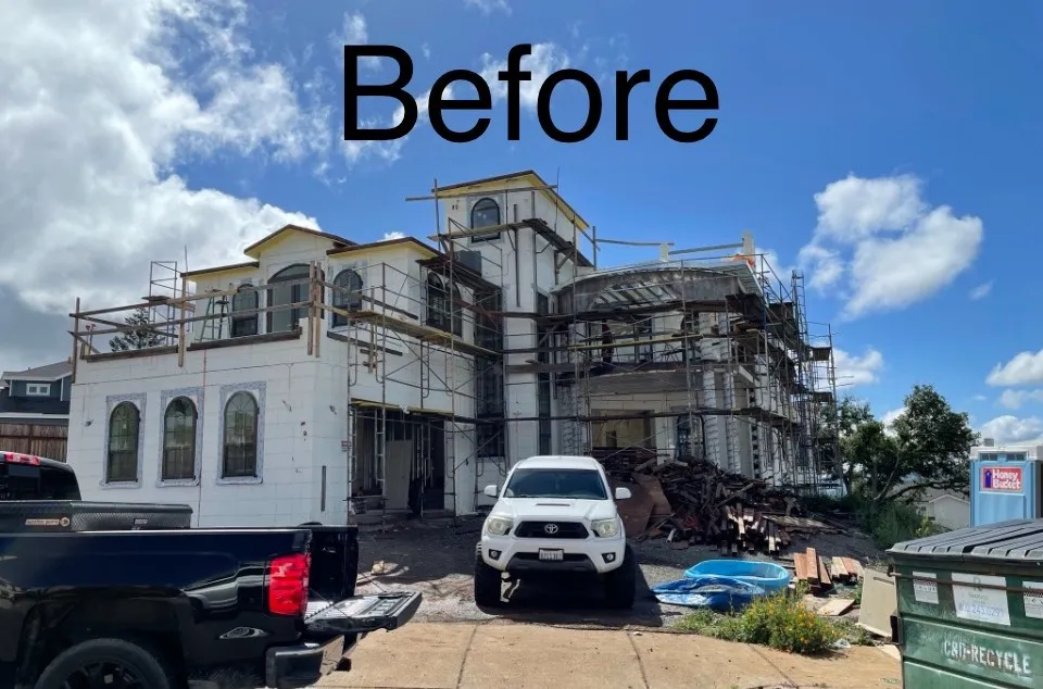 Block-built structure wrapped in scaffolding before stucco and stonework (before)