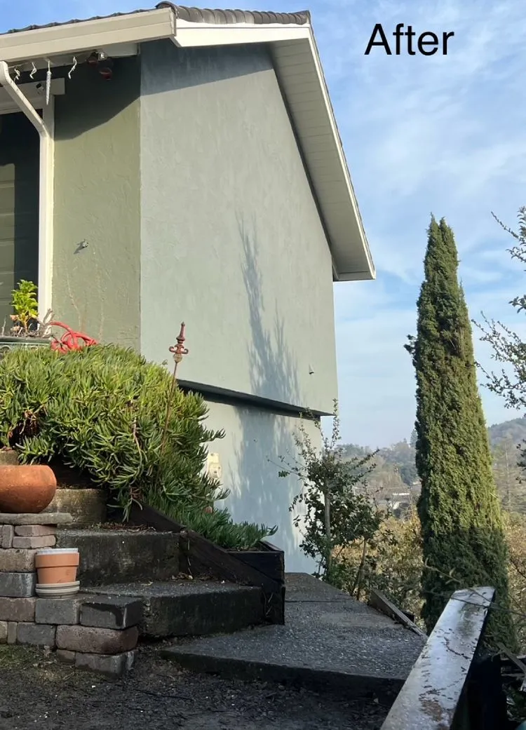 Restored wall with a smooth new stucco finish on a hillside home (after) — stucco restoration in Novato