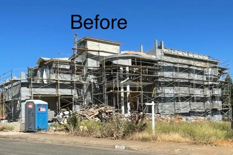 Scratch and brown coat stucco applied across the estate exterior with scaffolding in place (during)