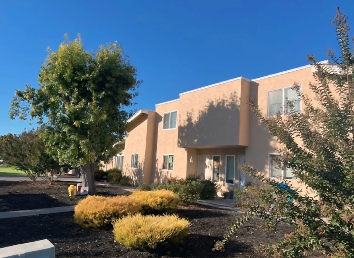 Tan stucco townhome complex with fresh landscaping after a full siding-to-stucco conversion in the Bay Area